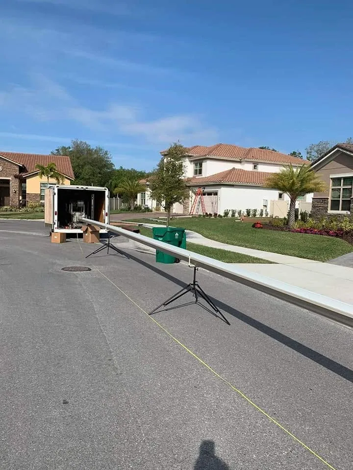 Long seamless gutter run tripod stands street white trailer, Sanford